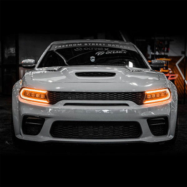 Front view of Dodge Charger with Alpha Black NOVA Series projector headlights glowing amber