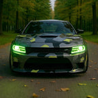 Custom Dodge Charger with multicolor projector headlights in green at forest road